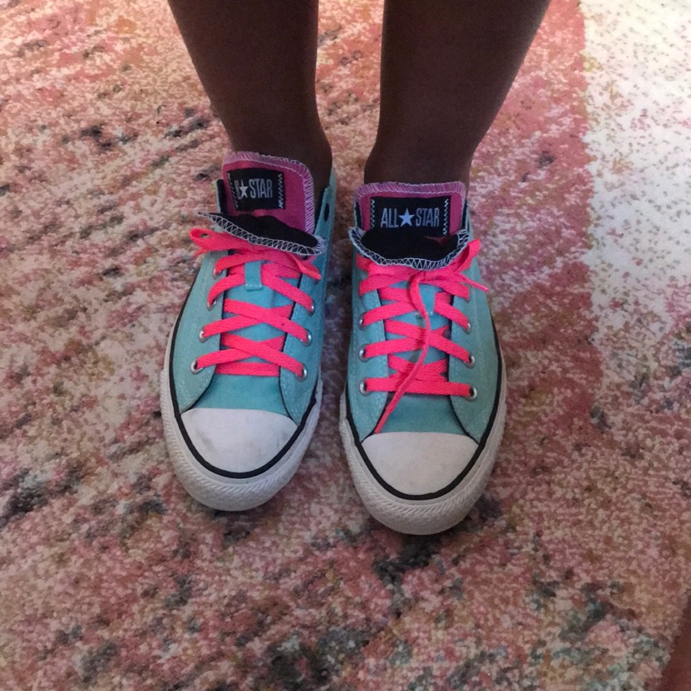 Green low top Converse sneakers.